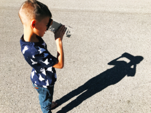 young boy using a sunlight obscura